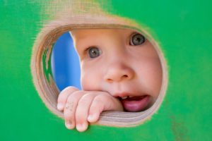 Baby looking through hole